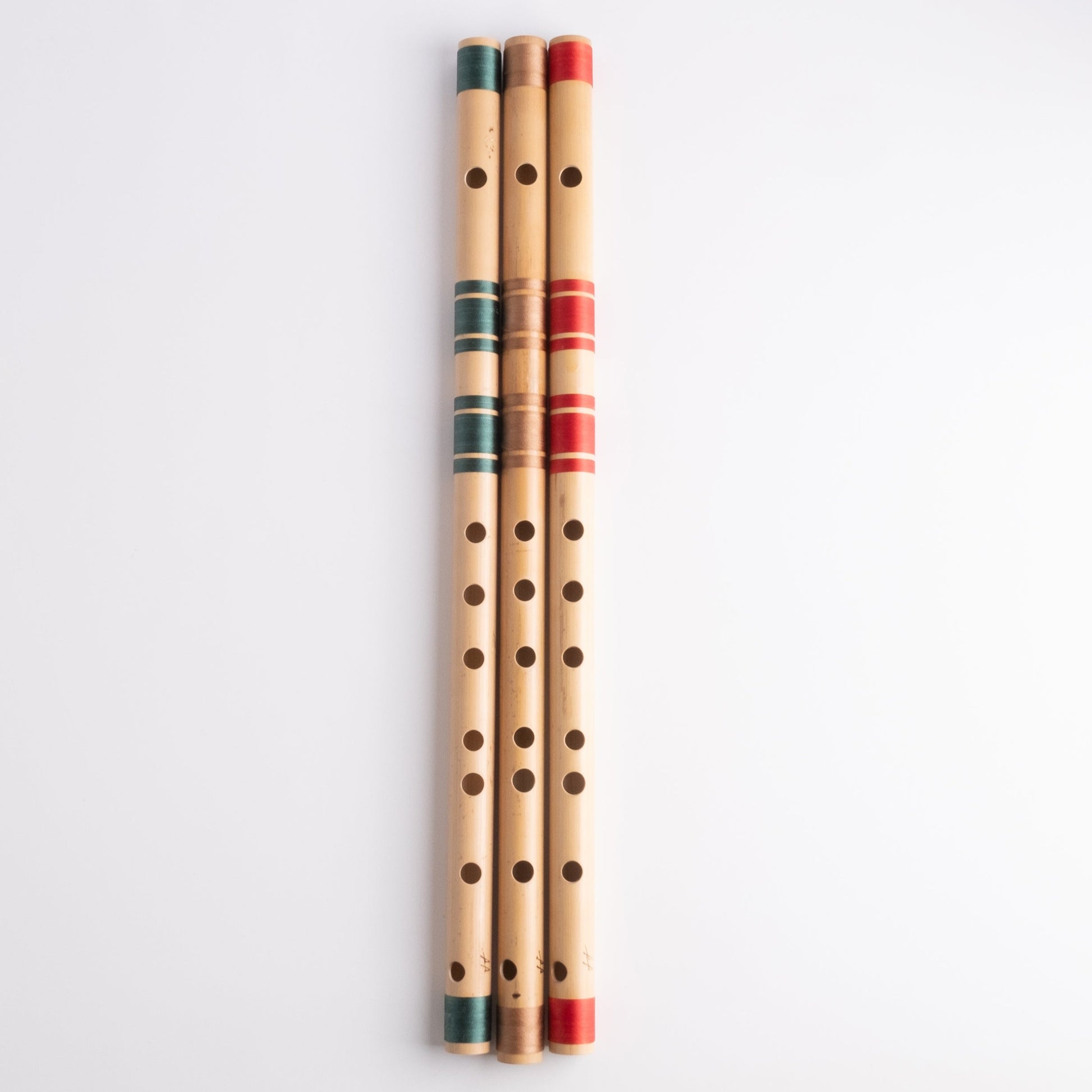 A# bansuri's in green, gold and red thread color